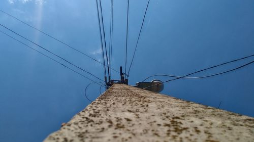 Low angle view of telephone pole against sky