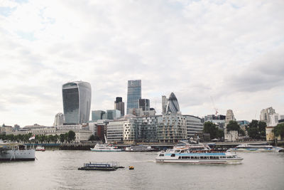 30 st mary axe by thames river against sky in city