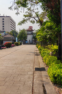 Footpath amidst buildings in city