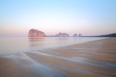 Scenic view of sea against clear sky during sunset