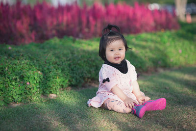 Cute girl sitting on grass