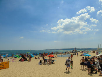 People on beach against sky