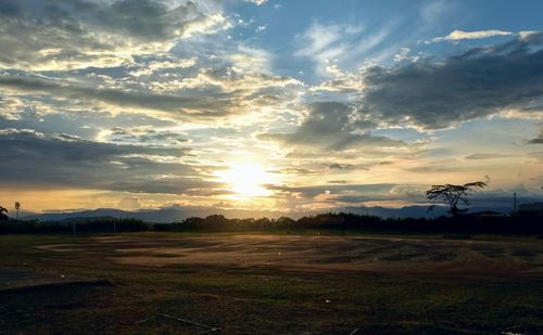 Scenic view of field against sky during sunset