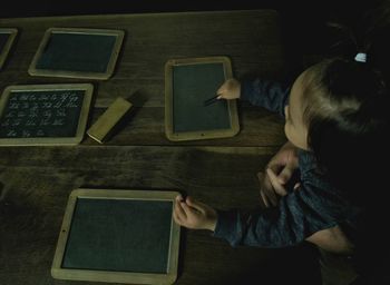 Directly above shot of boy using laptop on table