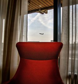 Chair seen through window of airplane