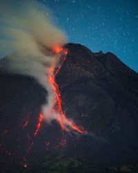 Scenic view of mountains against sky at night