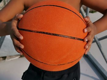 Midsection of man playing with ball