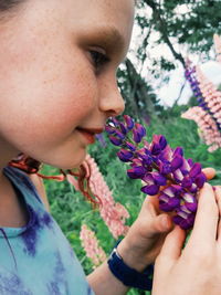 Close-up of girl smelling flowers