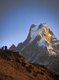 Scenic view of snowcapped mountains against clear sky
