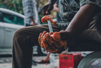 Midsection of man preparing food