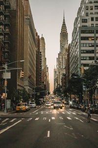 View of city street and buildings against sky