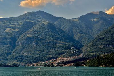 Scenic view of sea and mountains against sky