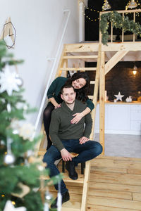 Happy couple in love are preparing for the christmas holiday in the decorated kitchen of the house