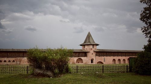 Built structure on field against sky