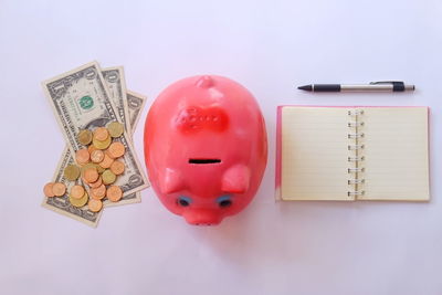 High angle view of coins on table against white background