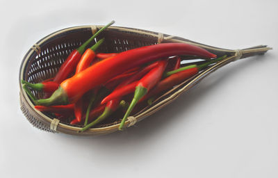 Close-up of red chili peppers in basket