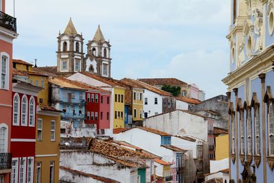 Buildings in town against sky