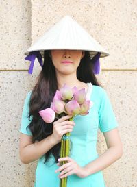 Front view of young woman with flowers