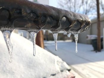 Close-up of icicles on metal during winter