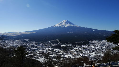 Aerial view of snowcapped mountains against clear sky