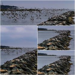 View of calm sea against rocky mountains