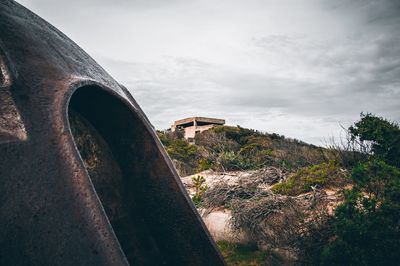 Abandoned car against sky