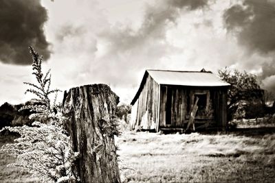 Built structure on field against cloudy sky