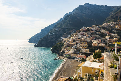 Panoramic view of sea and buildings against sky