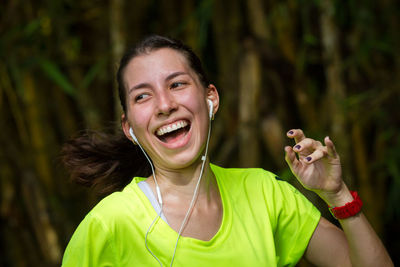 Portrait of smiling young woman with headphones exercising