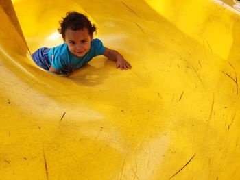 Portrait of girl enjoying slide