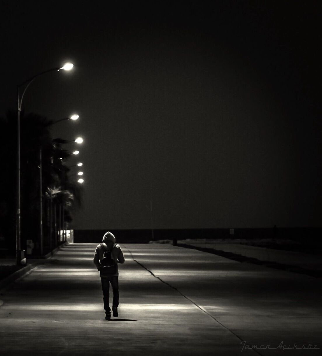 night, illuminated, one man only, one person, adults only, only men, street light, city, full length, rear view, outdoors, people, road, men, adult, sky