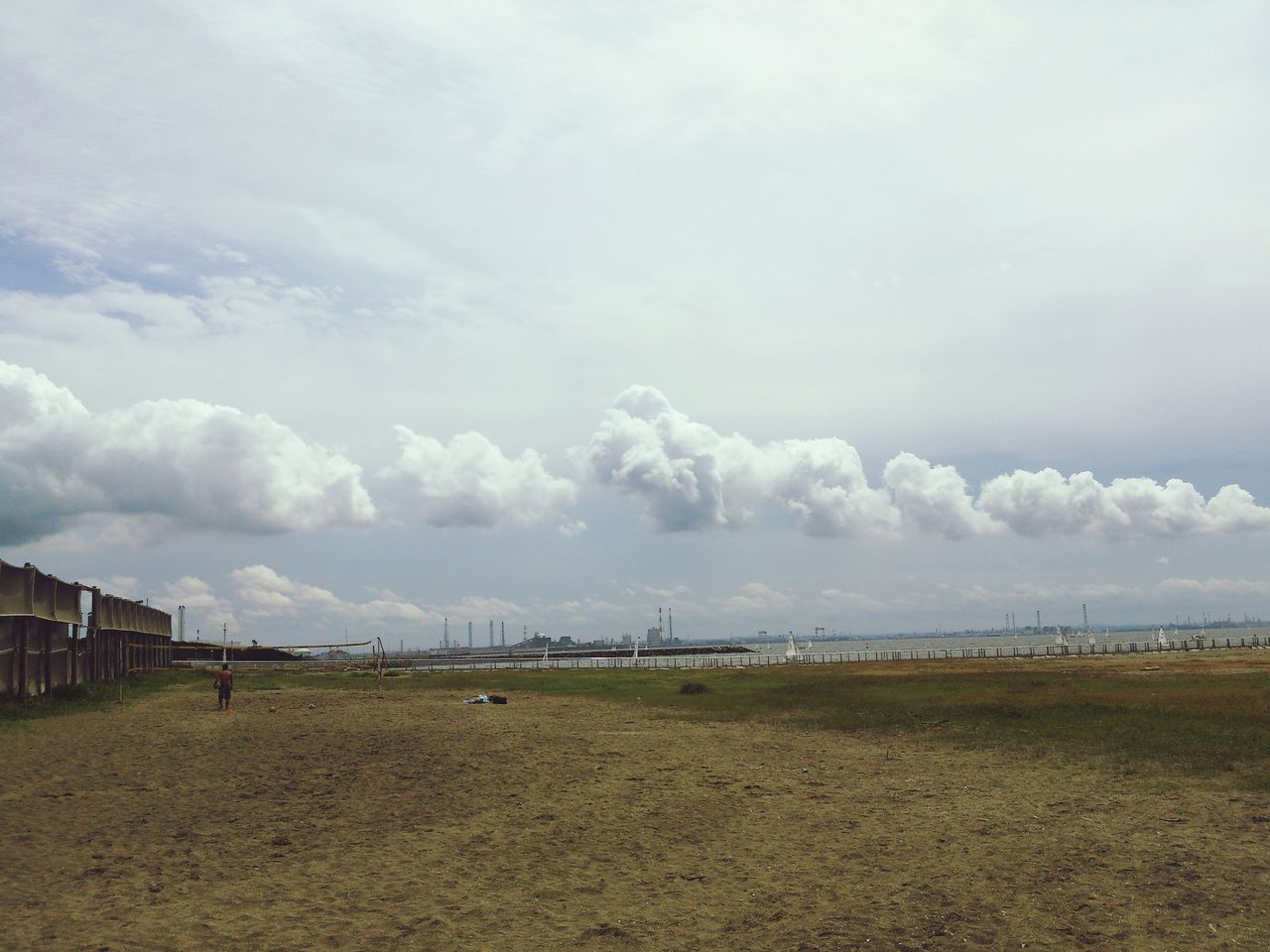 sky, cloud - sky, landscape, cloudy, field, tranquil scene, tranquility, cloud, nature, built structure, scenics, day, weather, sand, building exterior, beauty in nature, overcast, rural scene, outdoors, beach