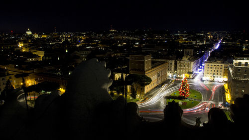 Aerial view of illuminated city buildings at night