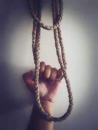 Close-up of human hand holding rope