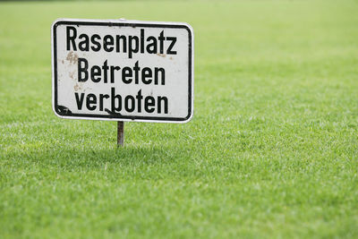 Close-up of warning sign on field