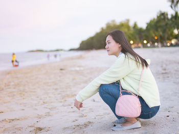 Young woman sitting at beach