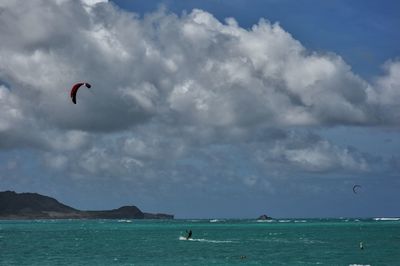 People kiteboarding on sea