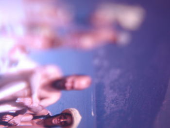 Close-up of man holding purple water