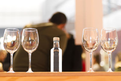 Close-up of wine glasses on table