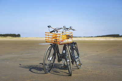 Denmark, romo, bicycles left on sandy beach