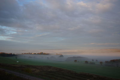 Scenic view of farm against sky