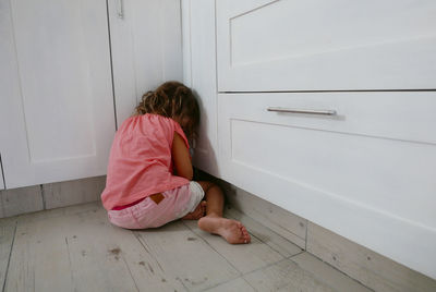 Young girl sitting on floor