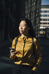 Woman with smartphone enjoying the sun