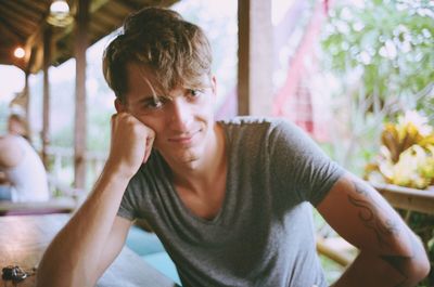 Portrait of young man sitting outdoors