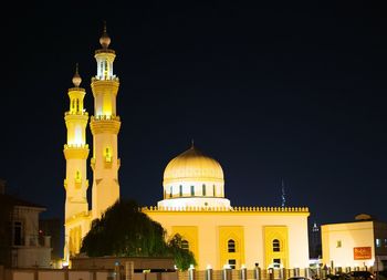 Low angle view of illuminated cathedral against sky at night