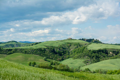 Scenic view of landscape against cloudy sky