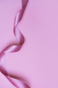 High angle view of pink petals on purple background