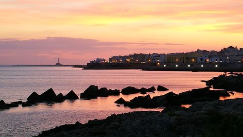 Scenic view of sea against romantic sky at sunset