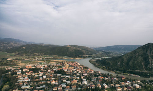 High angle view of townscape and mountains against sky