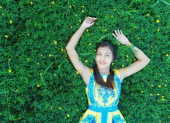 Young woman smiling while standing on grass